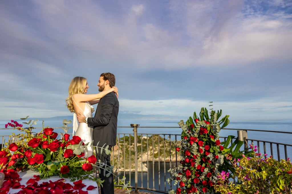 Couple embracing during sunset proposal on La Rotonda sul Mare terrace overlooking Isola Bella