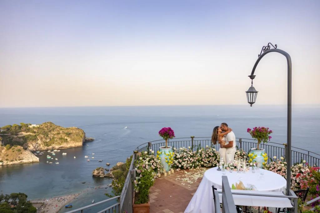 Man proposing on one knee on La Rotonda sul mare, the private terrace of the Grand Hotel San Pietro in Taormina