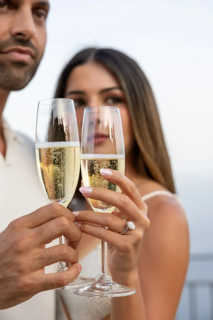 Close-up of an engagement ring during a champagne toast in Taormina