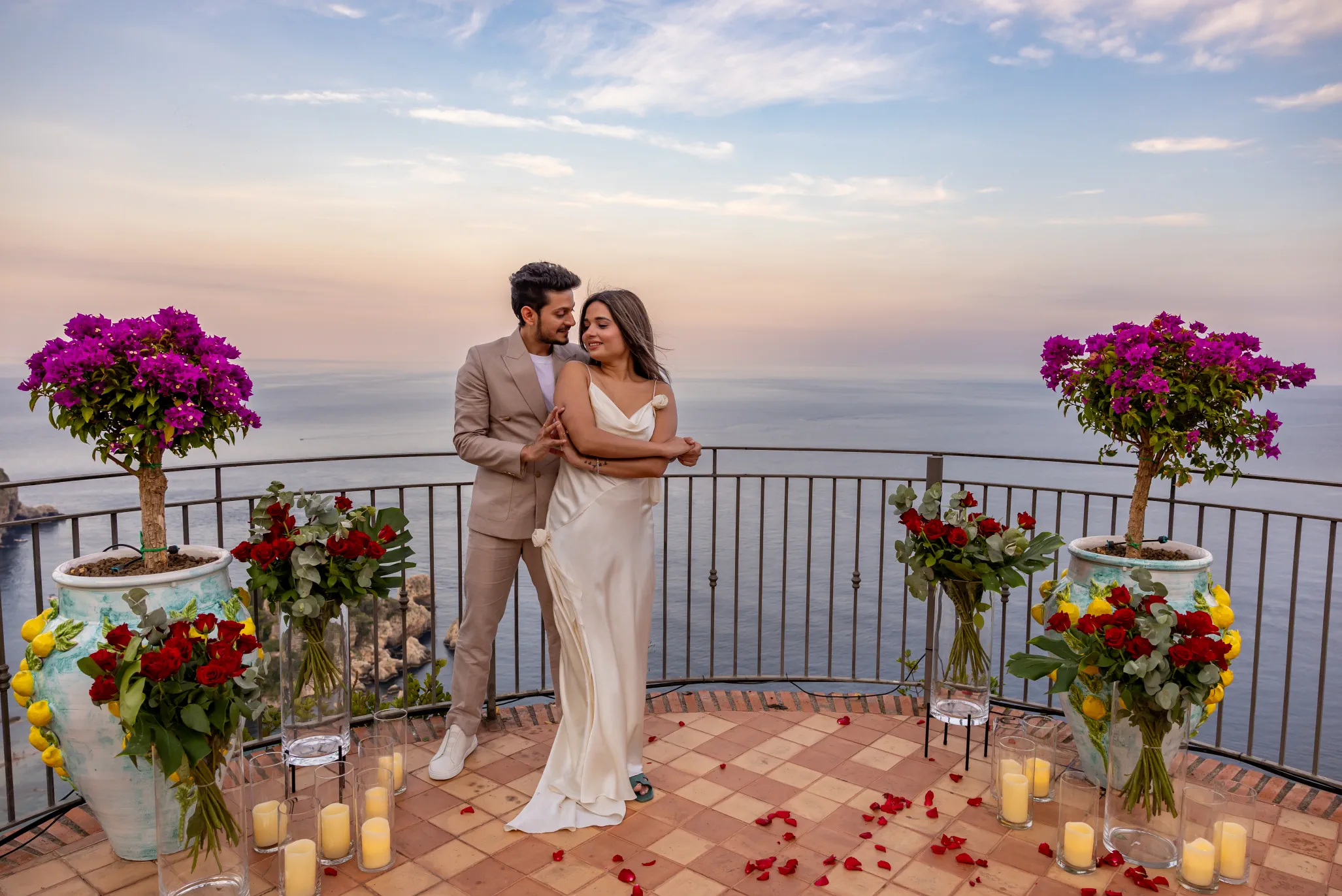 Sunset proposal in Taormina, couple embracing on the terrace
