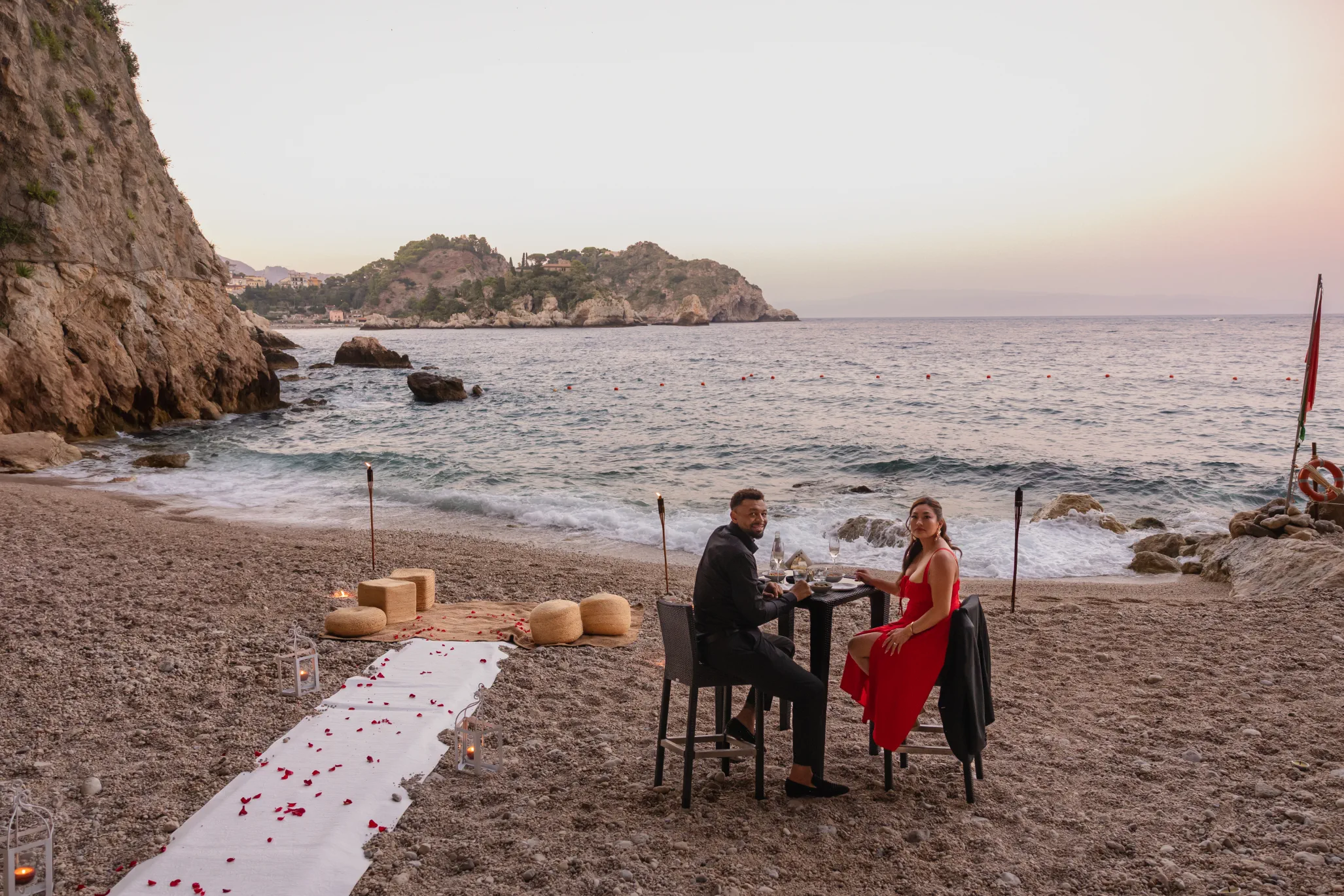 private dinner setup on the beach at Capotaormina