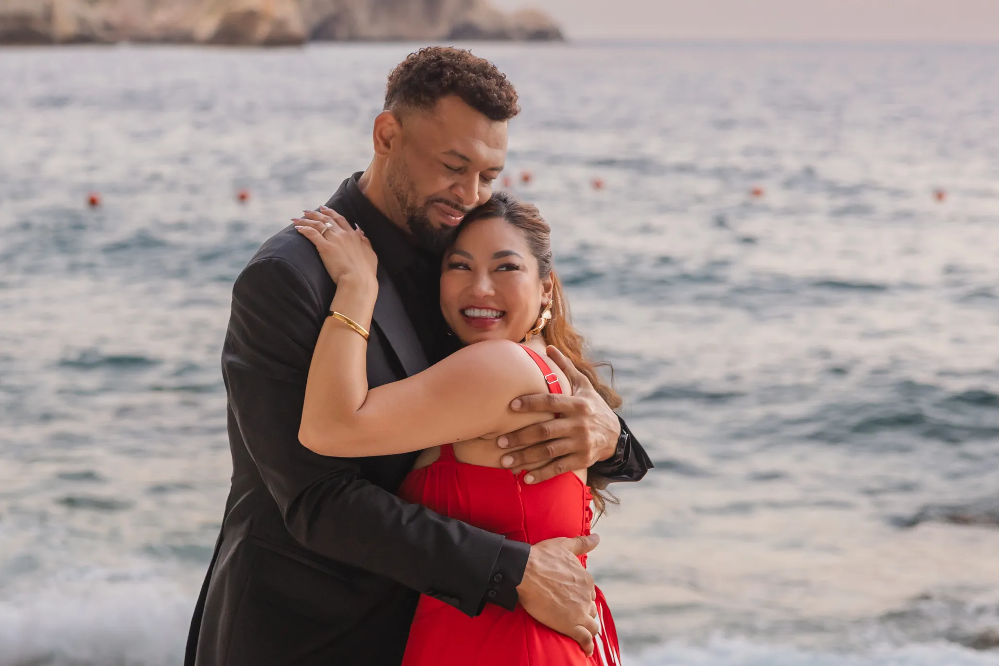couple embracing at Capotaormina hotel after their proposal