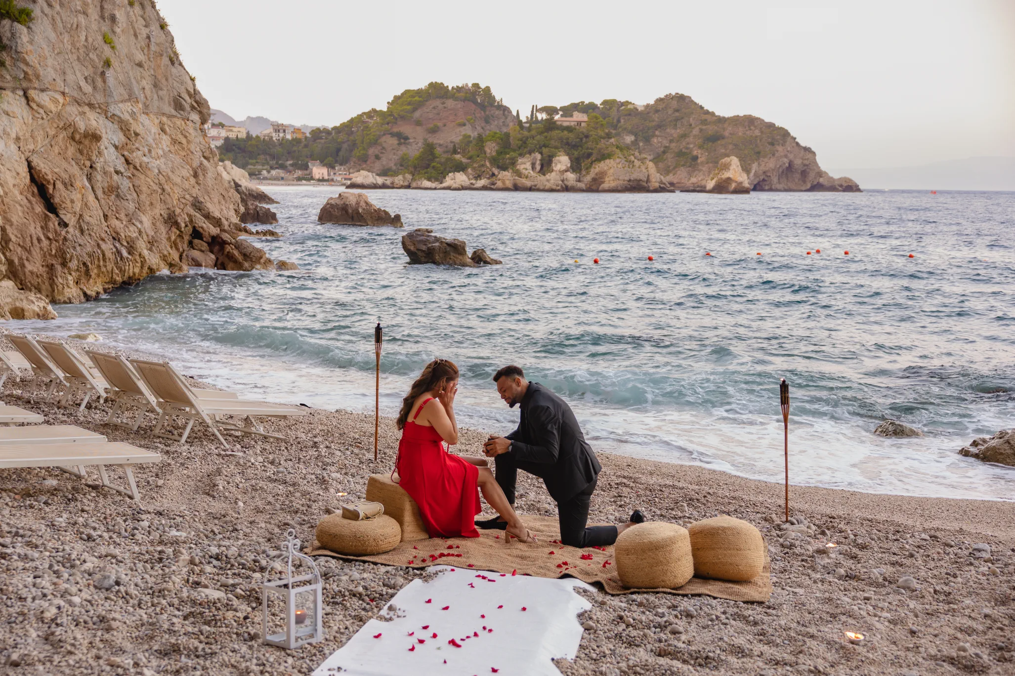 man proposing during private beach proposal in Taormina